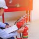 male inspector examining fire extinguishers floor 1024x648 1 80x80